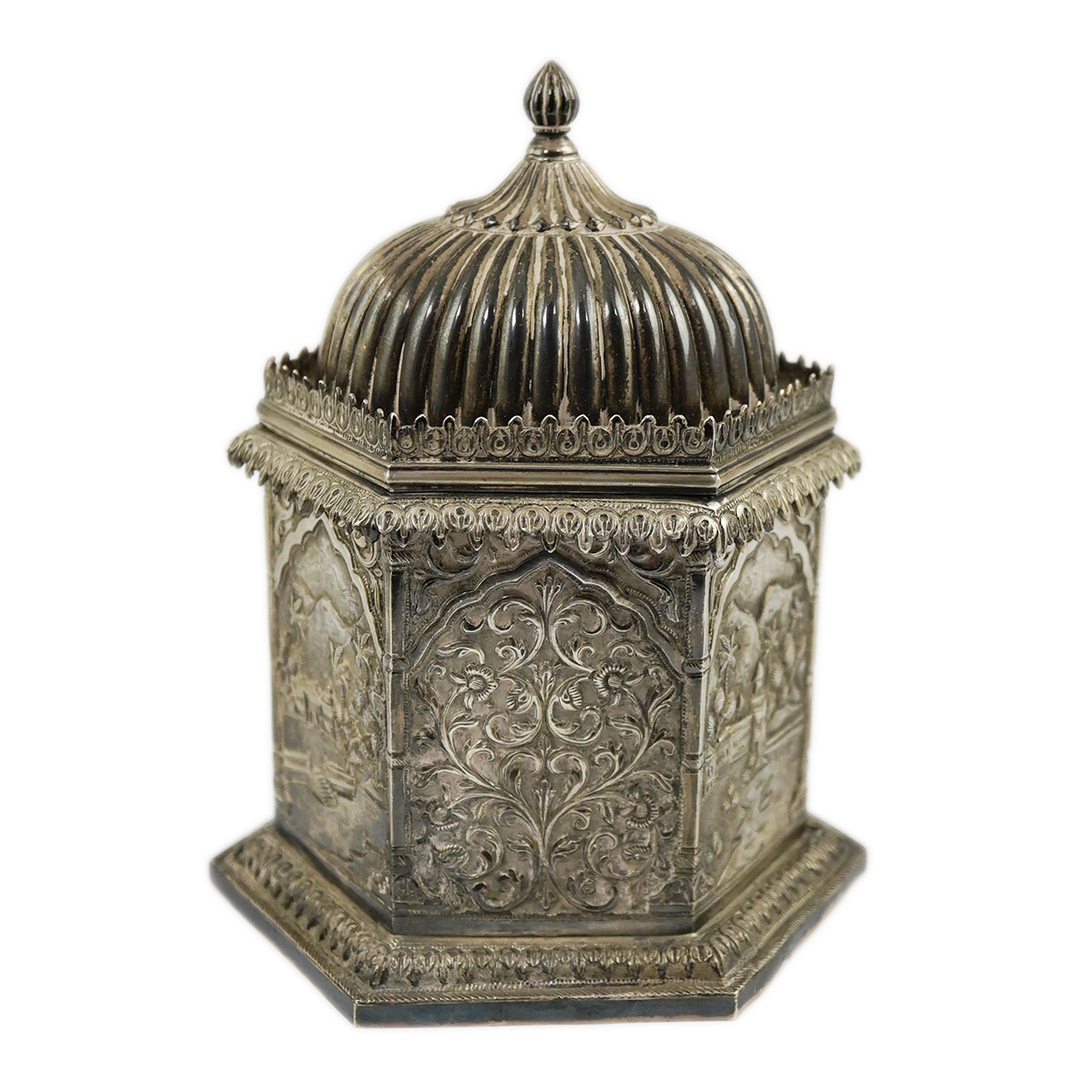 An early 20th century Indian embossed silver hexagonal box with fluted domed hinged cover